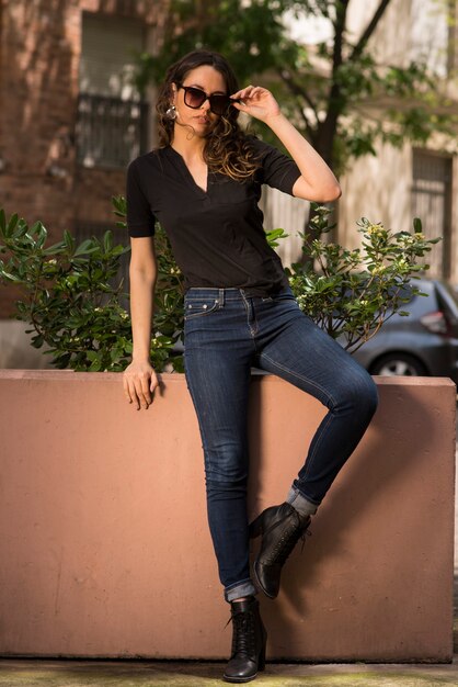 Beautiful young woman posing in the city