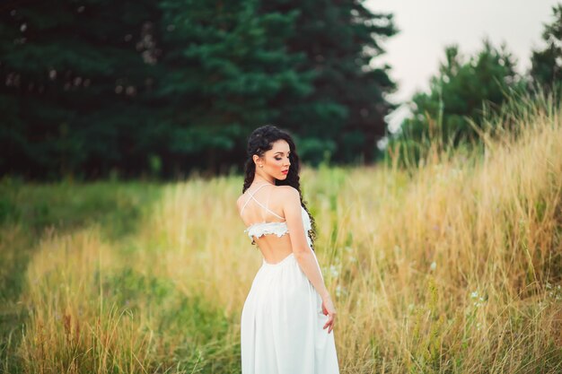 Beautiful young woman posing in the field