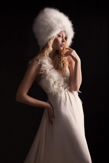 The beautiful young woman posing in a wedding dress