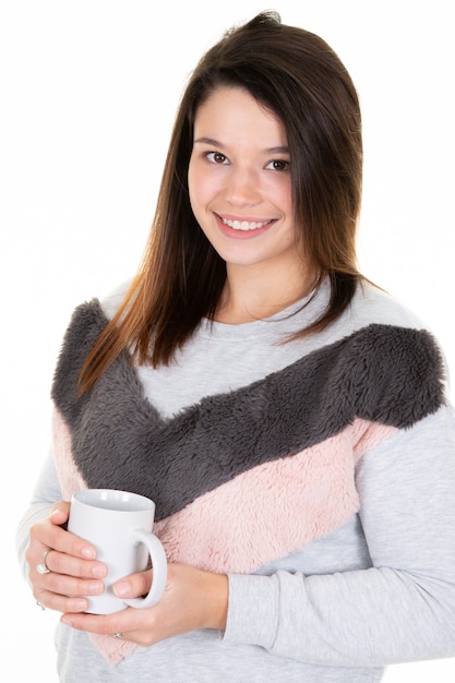 Beautiful young woman posing with cup of tea 