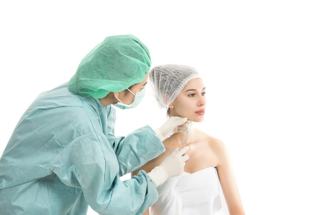 Beautiful young woman receiving Botox injection isolated on white background. Beauty concept.