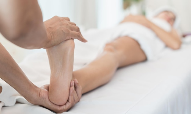 Beautiful young woman receiving massage in spa