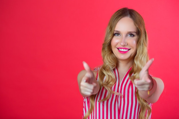 beautiful young woman on a red wall