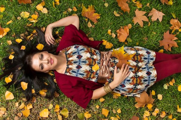Beautiful young woman relaxes on a park