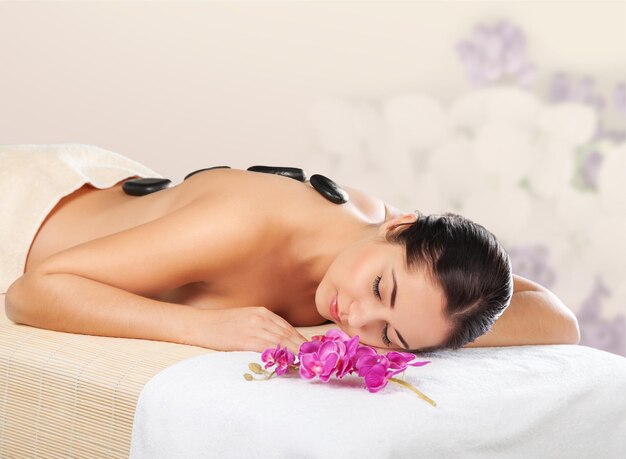 Beautiful young woman relaxing with massage at beauty spa