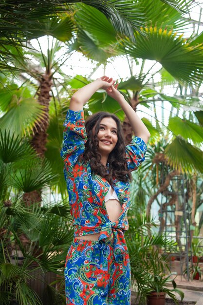 Beautiful young woman on resort near palm trees