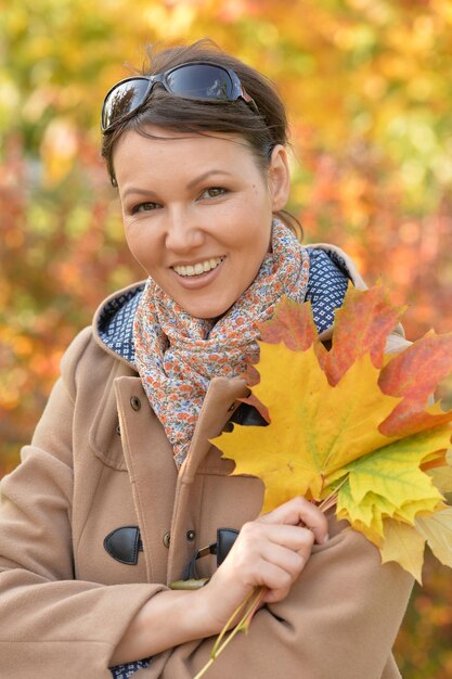 Beautiful young woman resting in autumnal park