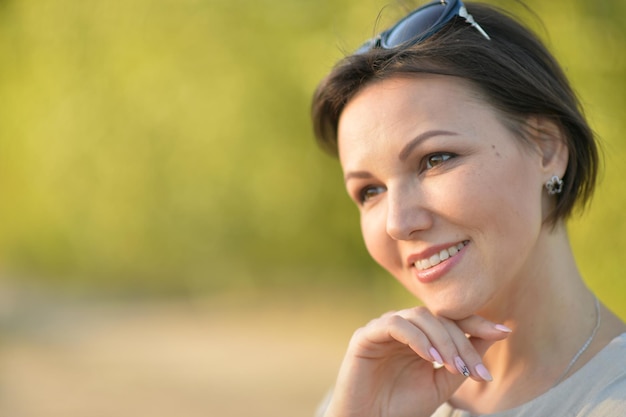 Beautiful young woman resting in a summer park