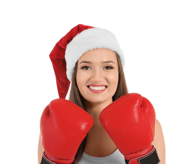 Beautiful young woman in Santa Claus hat and boxing gloves. Boxing Day concept