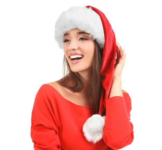 Beautiful young woman in Santa hat on white background