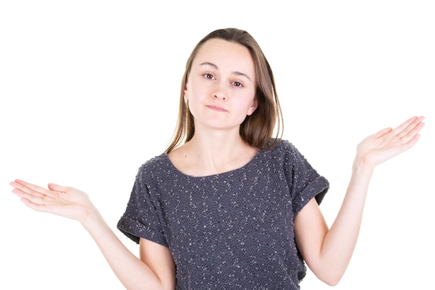 Beautiful young woman showing something on both empty hands for choice of products in white background studio