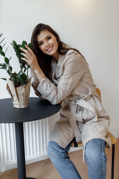 Beautiful young woman sitting at a table and smiling.