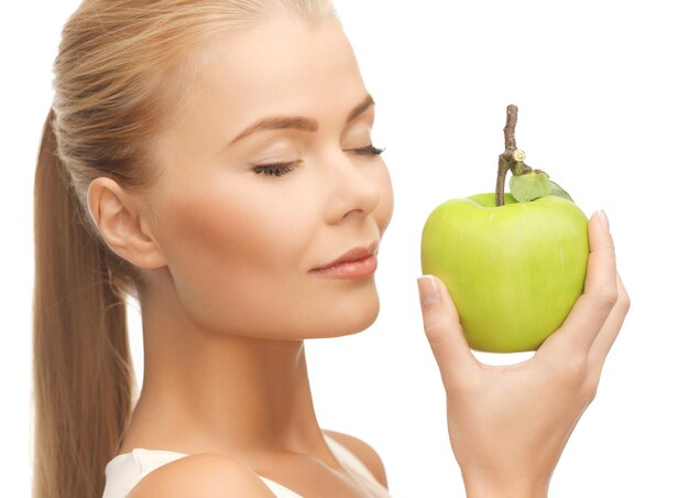 beautiful young woman smelling fresh green apple