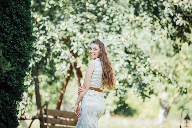 A beautiful young woman smiling outdoors.