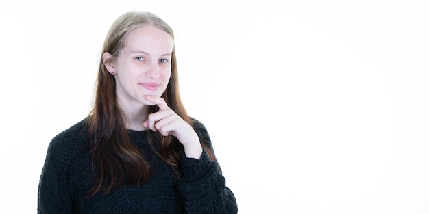 Beautiful young woman smiling pensive looking aside charming cute smile while posing against white copy space