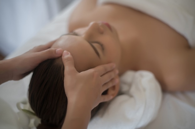 Beautiful young woman in spa salon