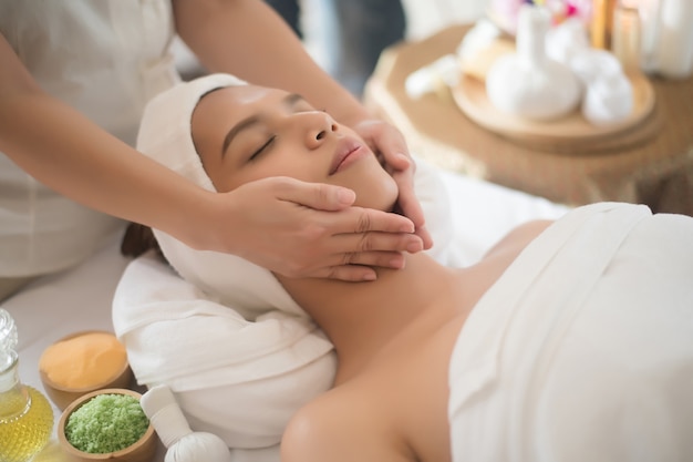 Beautiful young woman in spa salon