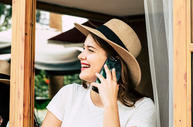 Beautiful young woman speak at the phone calling freinds outdoor