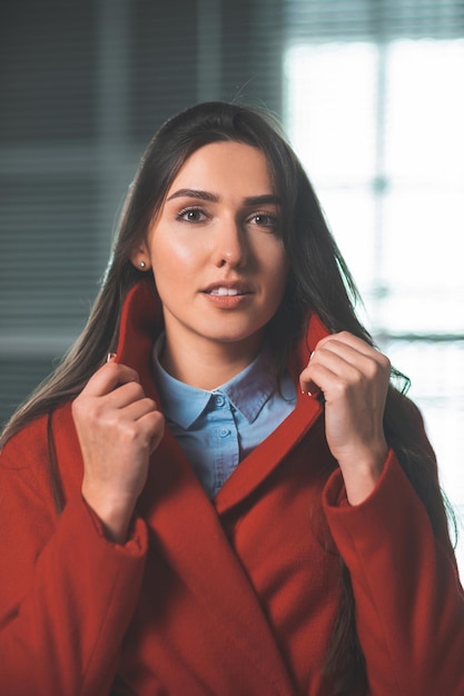 Beautiful young woman standing in front of an office building