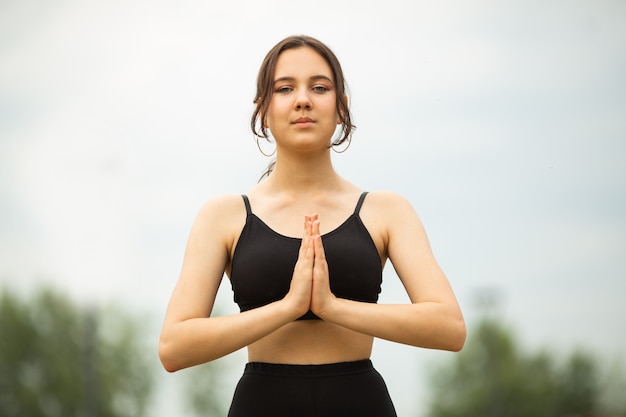 beautiful young woman on street sports yoga workout