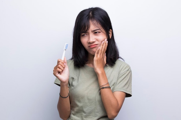 beautiful young woman suffering from toothache pain, tooth decay, tooth,  on white background