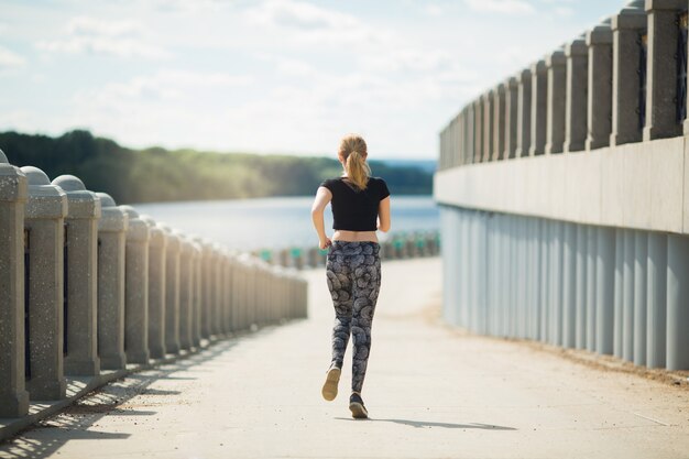 beautiful young woman in summer engaged in jogging