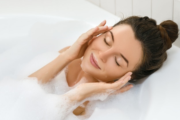 Beautiful young woman taking bath