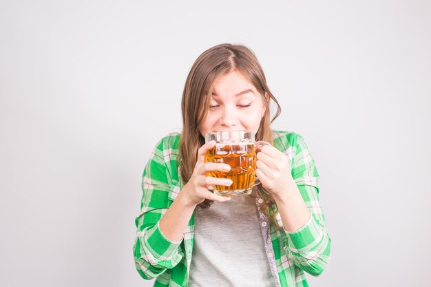 Beautiful young woman testing beer