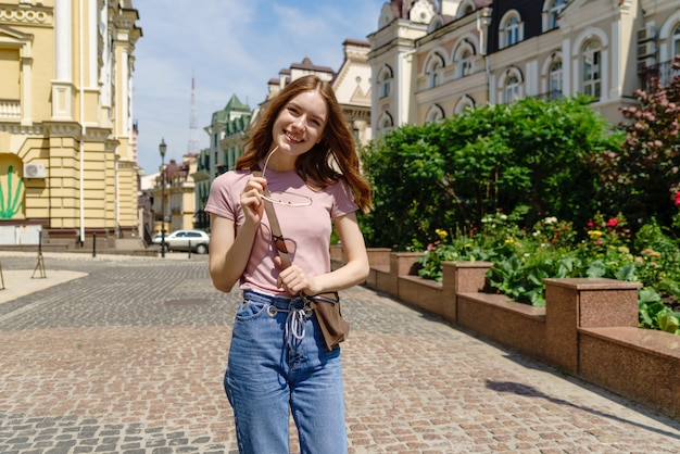 Beautiful Young Woman tourist walking in the City Center