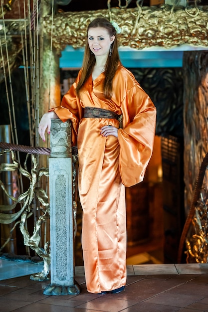 Beautiful young woman in traditional oriental kimono dress on the occasion of Chinese New Year celebration