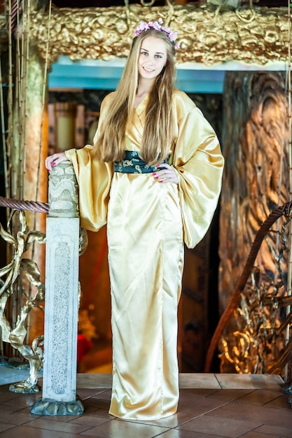 Beautiful young woman in traditional oriental kimono dress on the occasion of Chinese New Year celebration