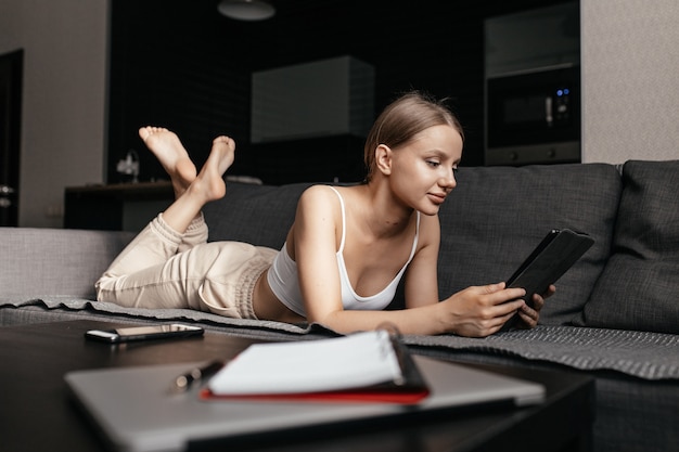 Beautiful young woman using electronic device