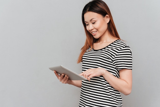 Beautiful young woman using tablet computer.