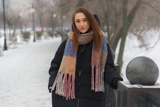 Beautiful and young woman walking in winter