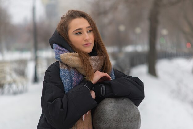 Beautiful and young woman walking in winter