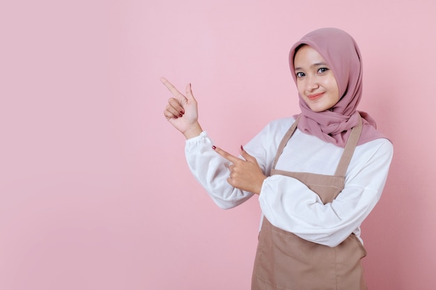 Beautiful young woman wearing apron with smile and happy