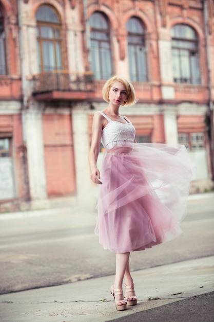 Photo beautiful young woman wearing dress in city