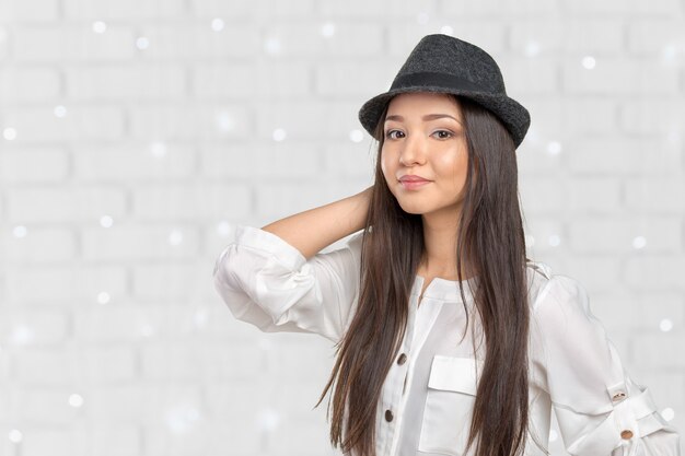 Beautiful young woman wearing summer fedora straw hat posing