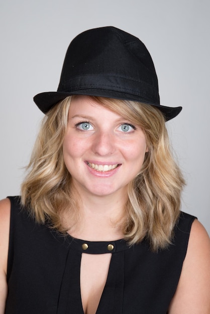 Beautiful young woman wearing summer fedora straw hat