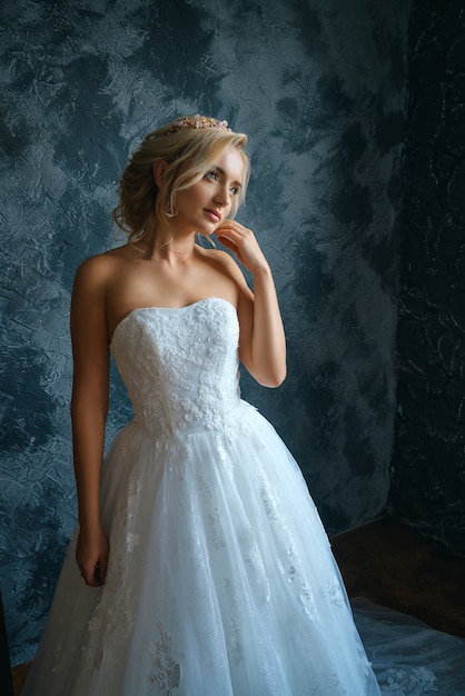 Beautiful young woman in wedding dress, beautiful bride with a make-up and hairstyle