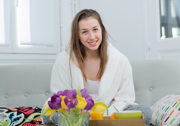 Beautiful young woman in white bathrobe