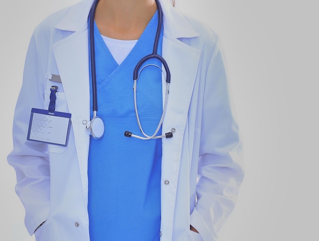 Beautiful young woman in white coat posing with hand in pocket\
woman doctor