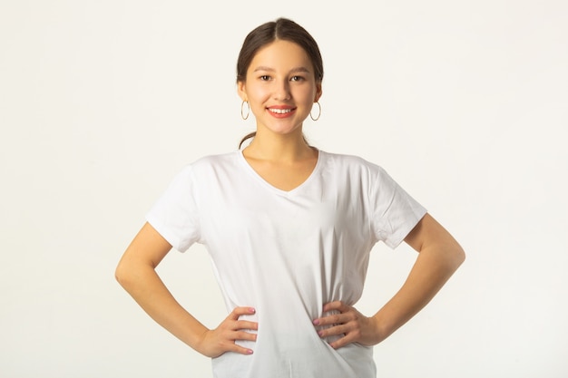 beautiful young woman in white t-shirt on a white background