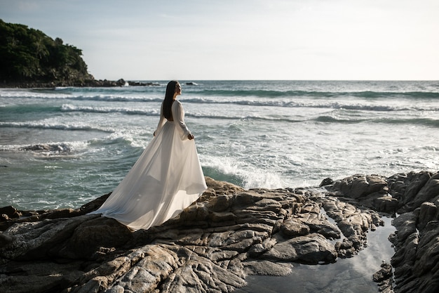 Beautiful young woman in a white wedding dress