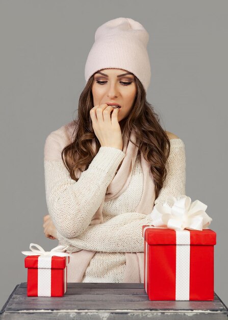 A beautiful young woman in winter clothes thoughtfully hesitan