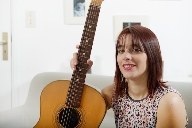 Beautiful young woman with acoustic guitar