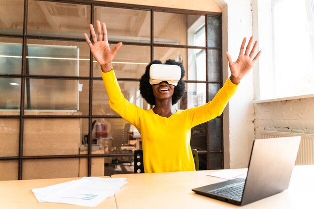 Beautiful young woman with the afro haircut working in the office