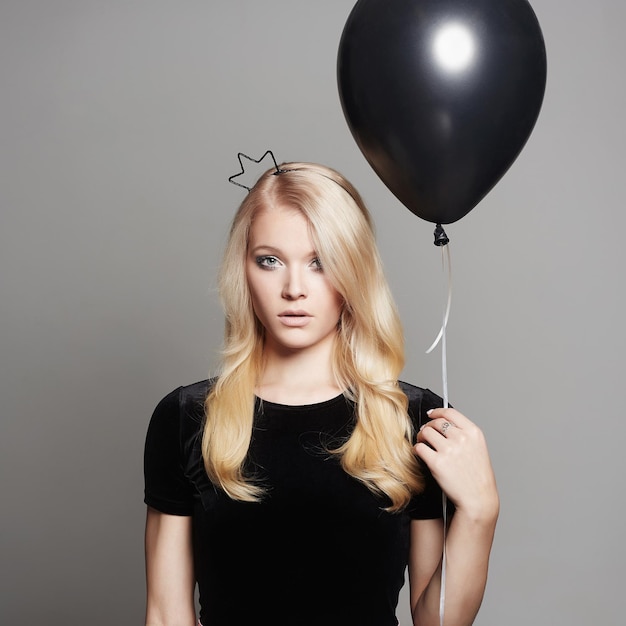 Beautiful young woman with air balloon