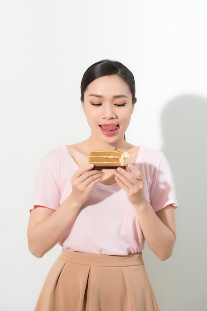 Beautiful young woman with appetizing cake - isolated on white