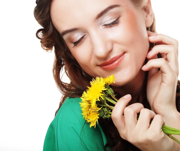 Beautiful young woman with big yellow dandelions